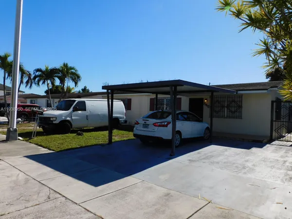 a couple of cars parked in front of a house