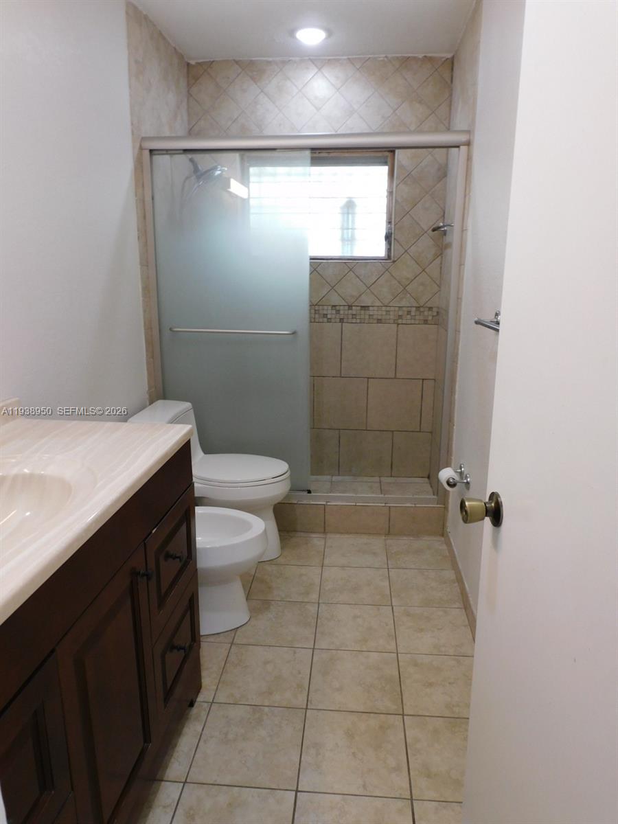 846 West 31st Street Hialeah, FL 33012 - Photo 14 of 21 Updated bathroom with walk-in shower with glass doors.