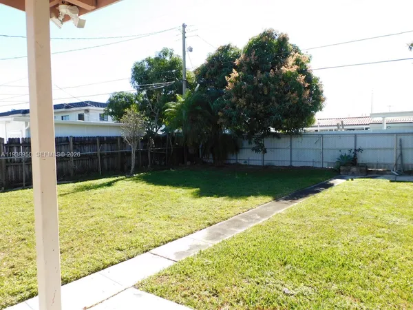 a view of backyard with swimming pool