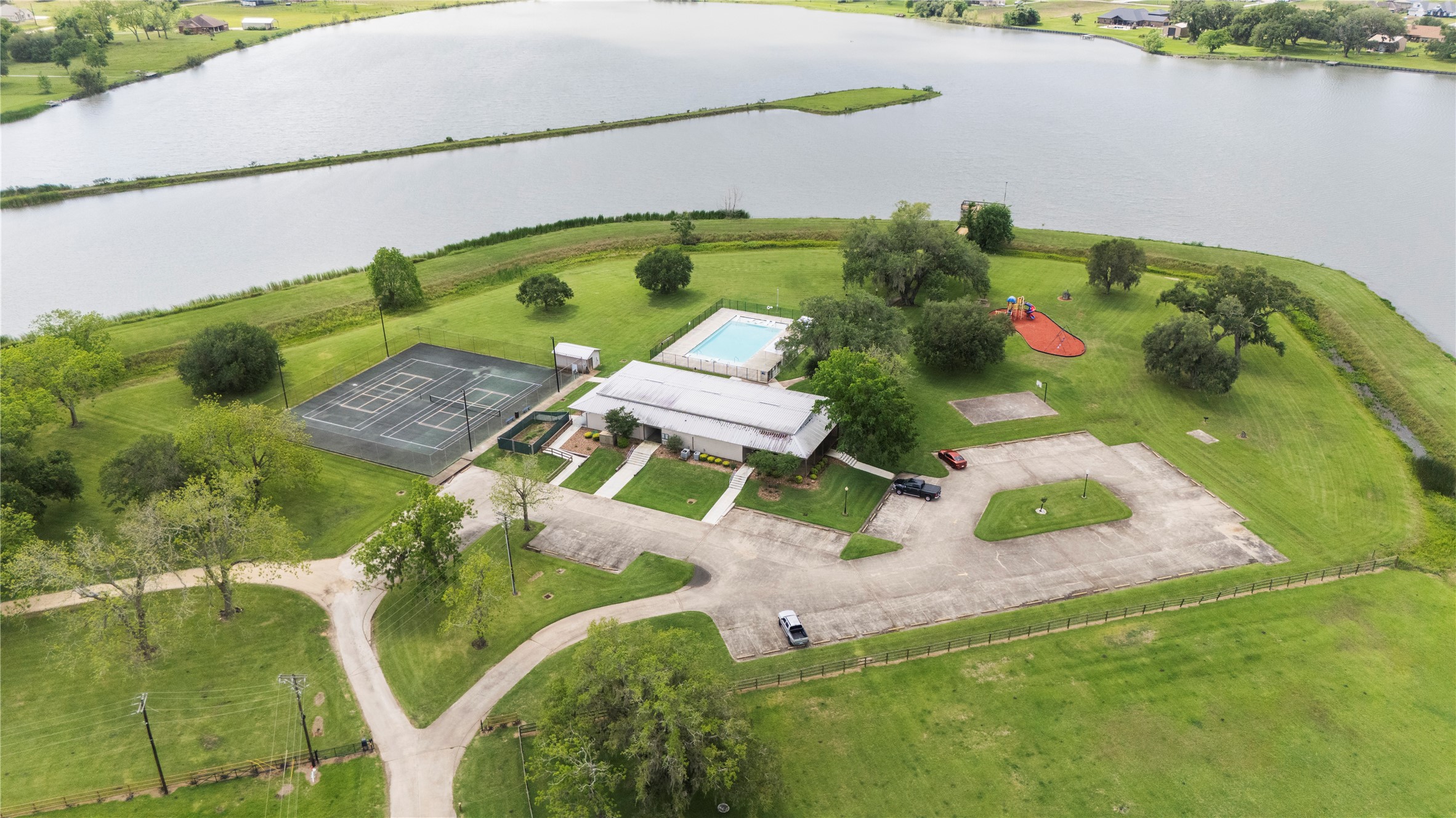 1127 Saddlehorn Bend Angleton, TX 77515 - Photo 18 of 23 an aerial view of a house with a yard and lake view