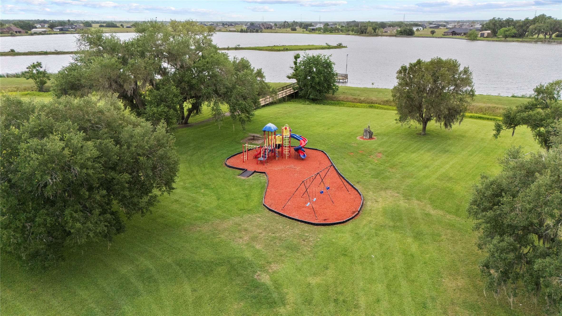 1127 Saddlehorn Bend Angleton, TX 77515 - Photo 20 of 23 a view of a lake with a yard