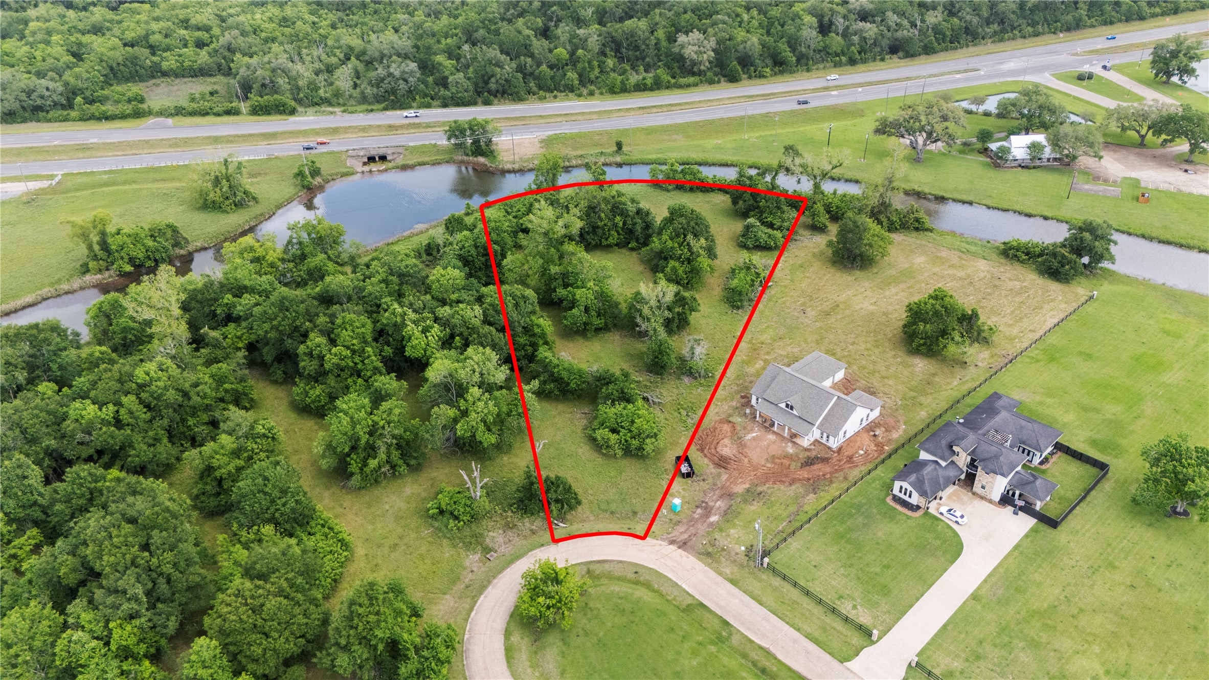 1127 Saddlehorn Bend Angleton, TX 77515 - Photo 2 of 23 an aerial view of a house with a yard and lake view