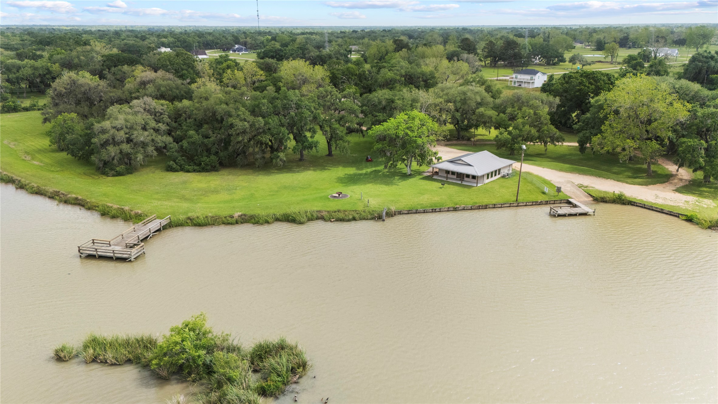 1127 Saddlehorn Bend Angleton, TX 77515 - Photo 22 of 23 an aerial view of a house with a yard and lake view
