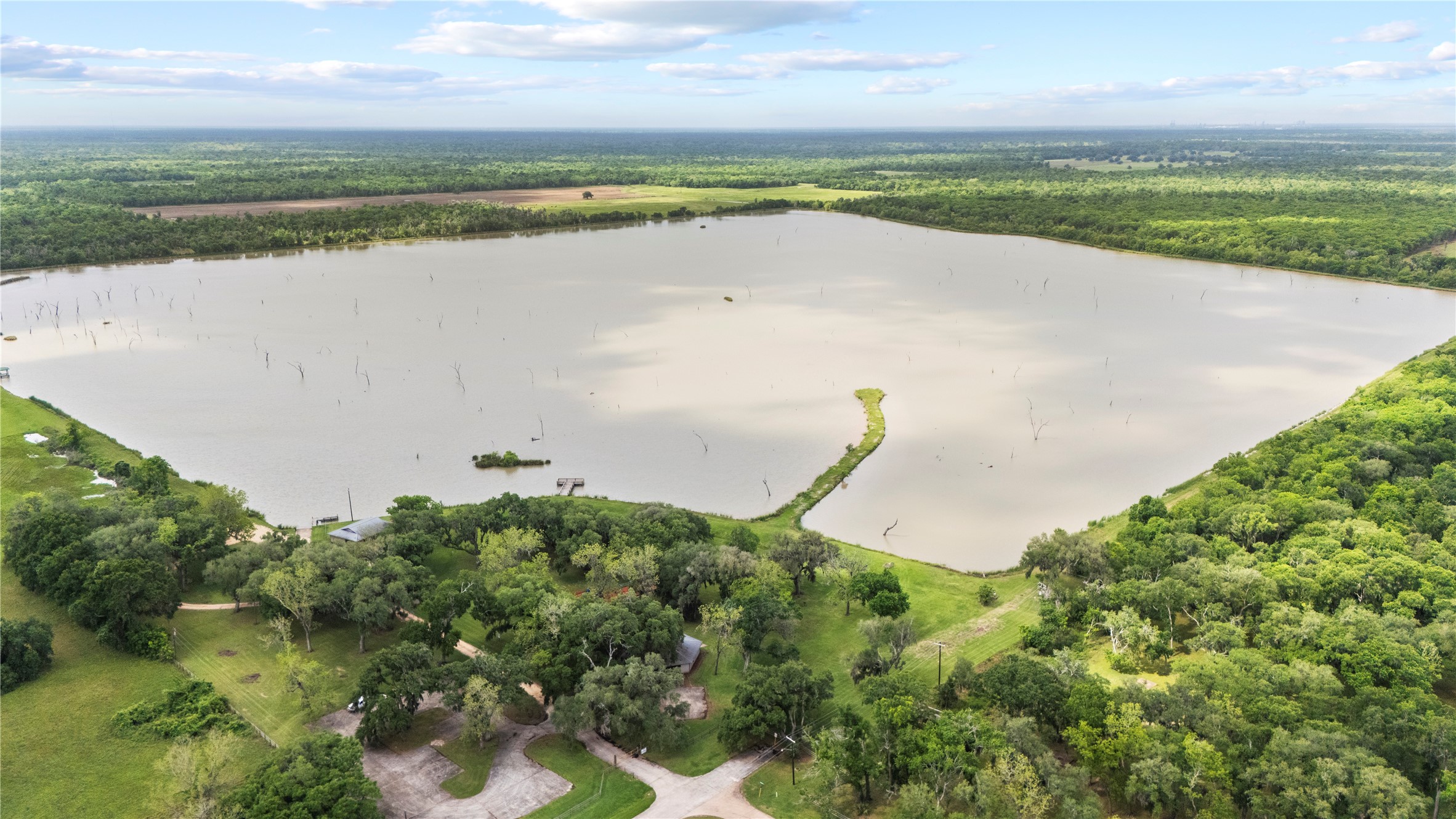 1127 Saddlehorn Bend Angleton, TX 77515 - Photo 8 of 23 a view of a lake with a yard