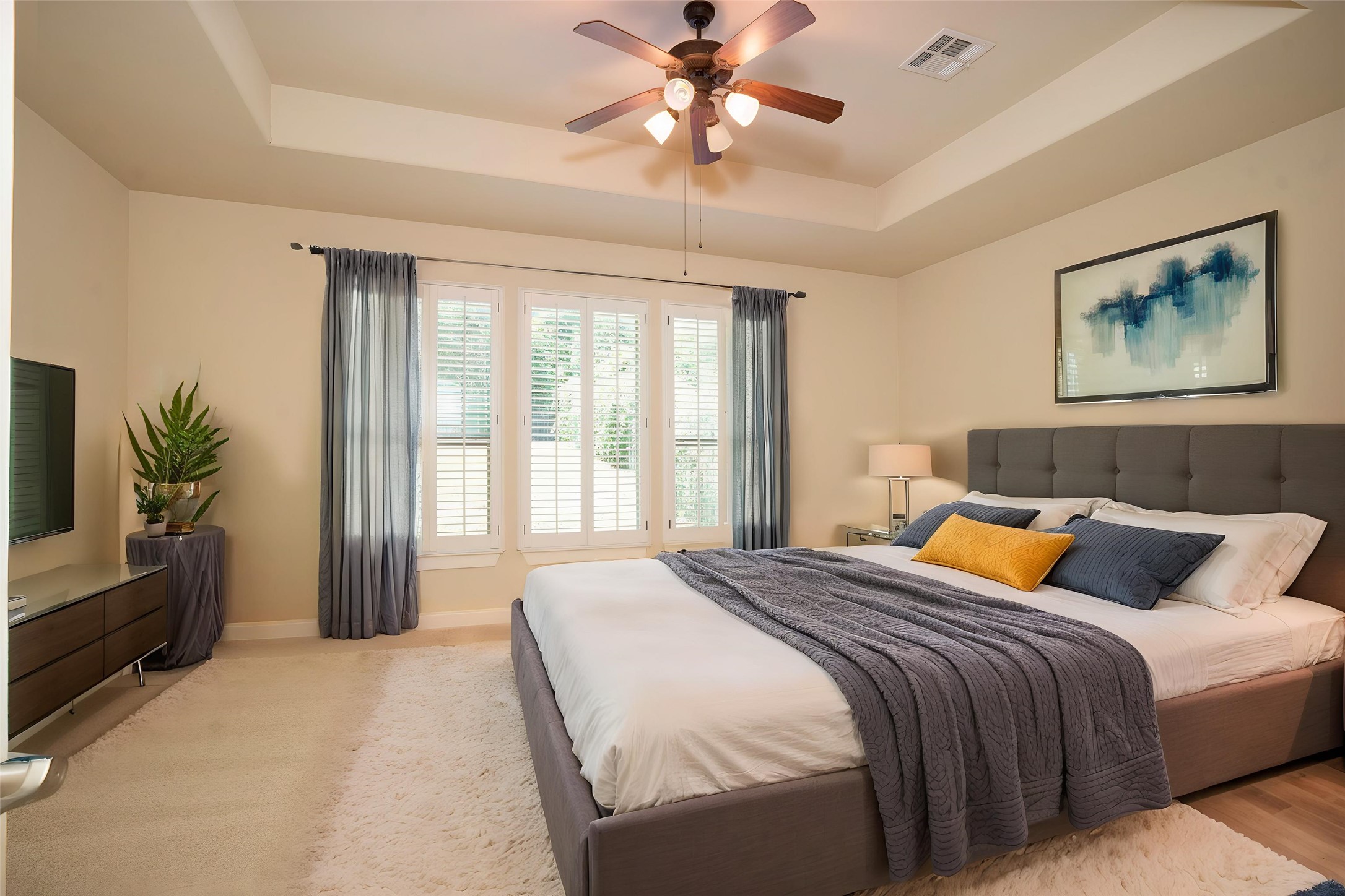 210 Rivulet Lane Austin, TX 78738 - Photo 12 of 28 A tranquil primary suite with vaulted ceilings and ample natural light invites relaxation.