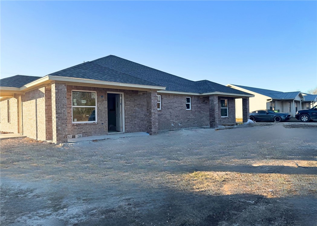 216 Melissa Street Eddy, TX 76524 - Photo 2 of 14 a front view of a house with a yard and garage