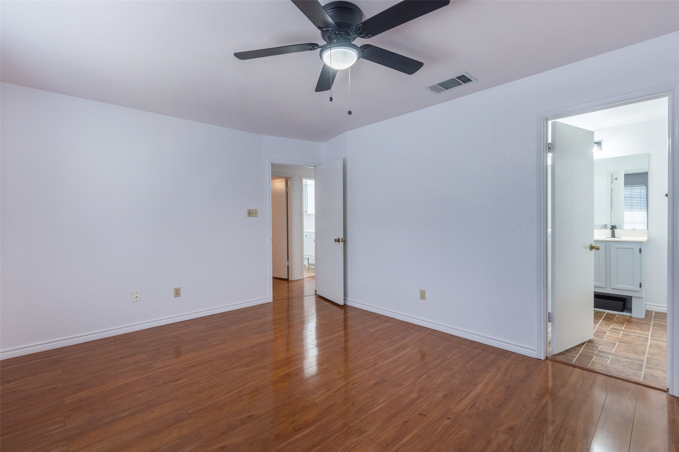 8506 Bisbee Court Austin, TX 78745 - Photo 16 of 20 Spacious room featuring wood-finish flooring and a ceiling fan with integrated lighting