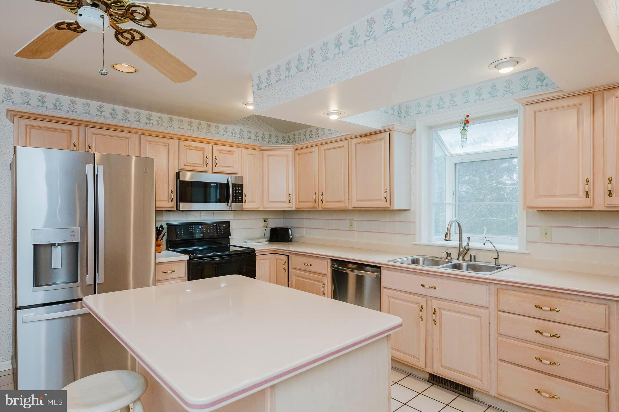 1303 Mill Creek Road Fallston, MD 21047 - Photo 14 of 58 a kitchen with stainless steel appliances a sink stove refrigerator and cabinets