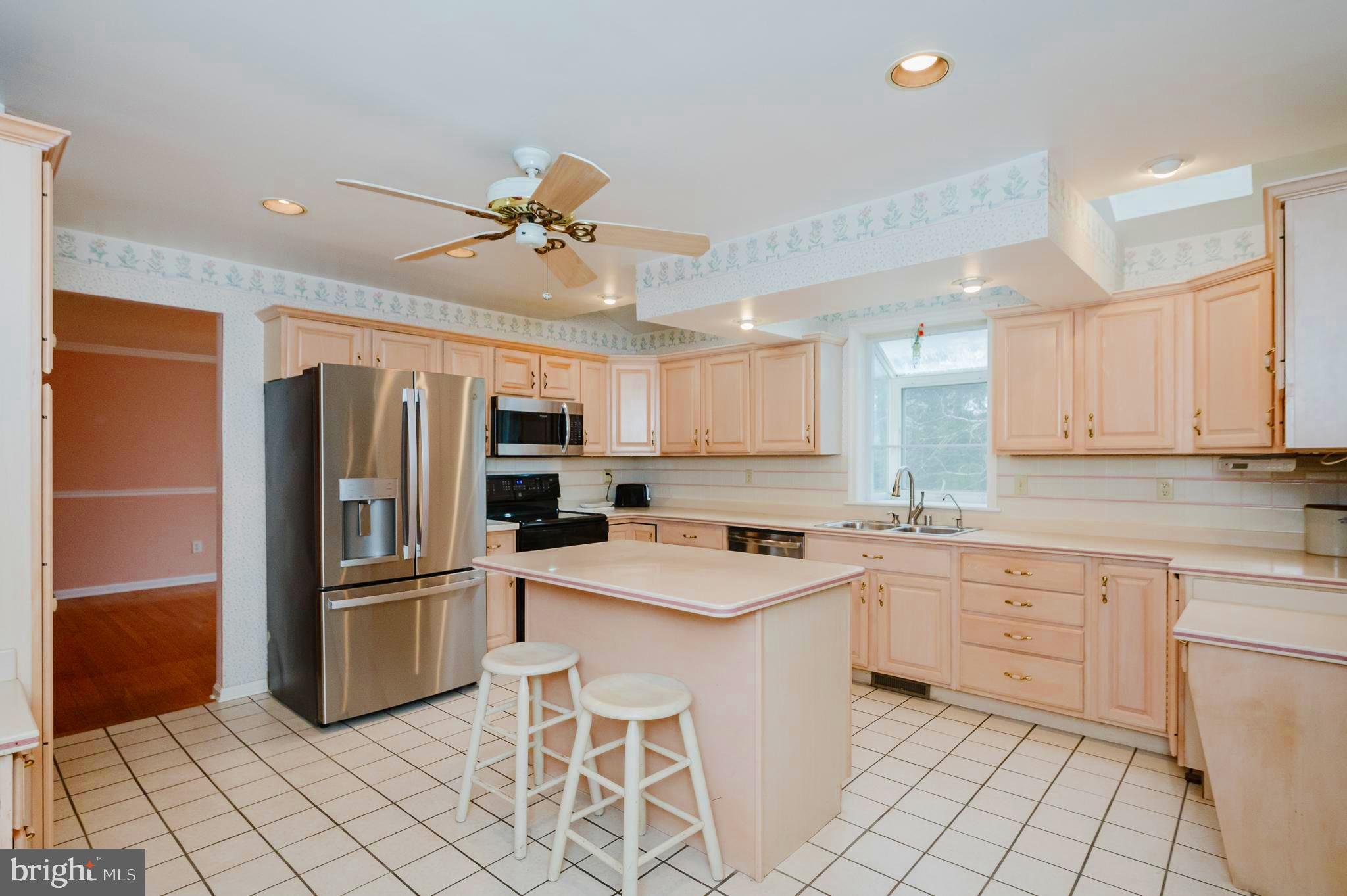 1303 Mill Creek Road Fallston, MD 21047 - Photo 15 of 58 a kitchen with white cabinets and stainless steel appliances