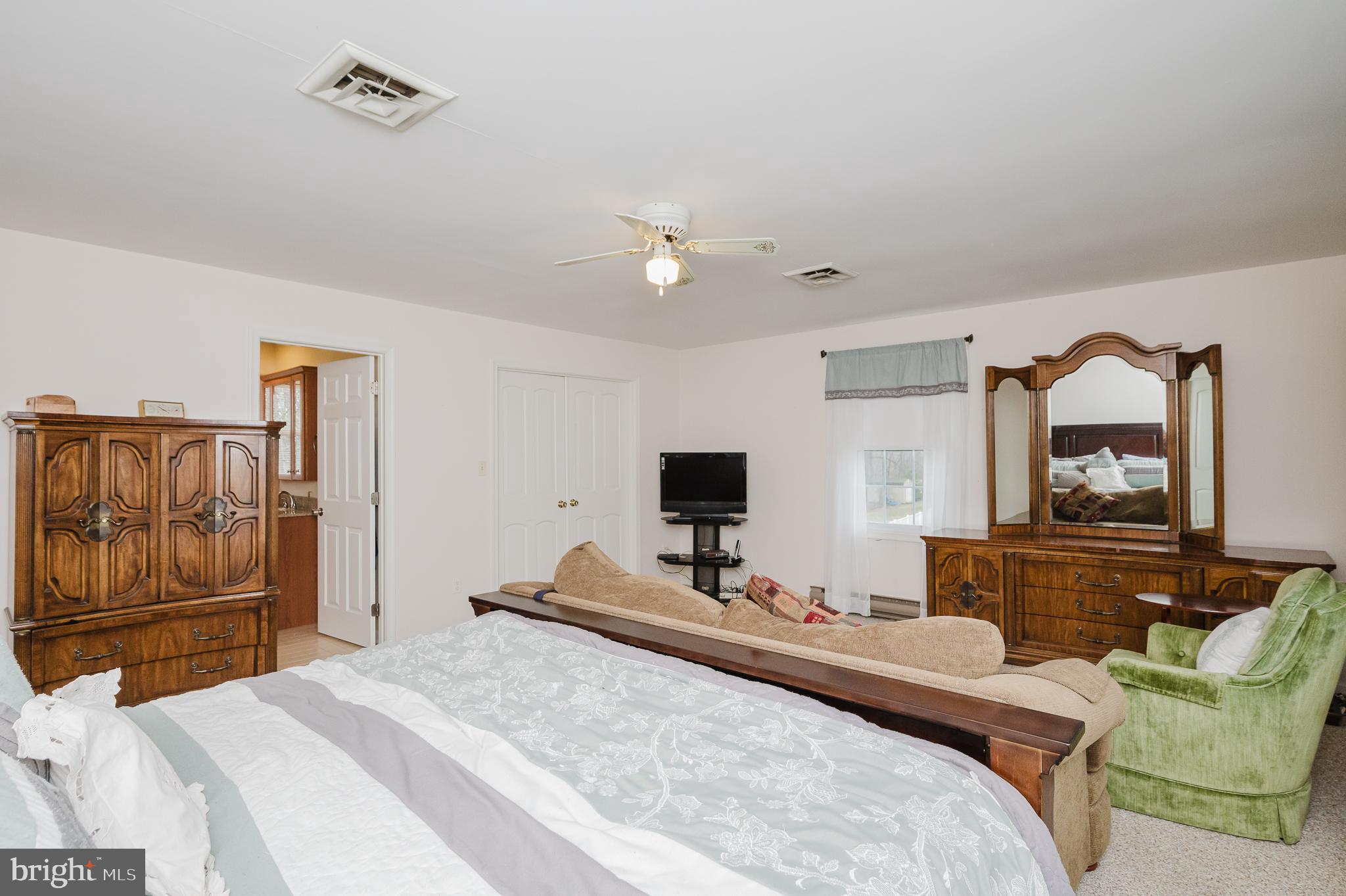 1303 Mill Creek Road Fallston, MD 21047 - Photo 32 of 58 a bedroom with a bed and dresser with mirror