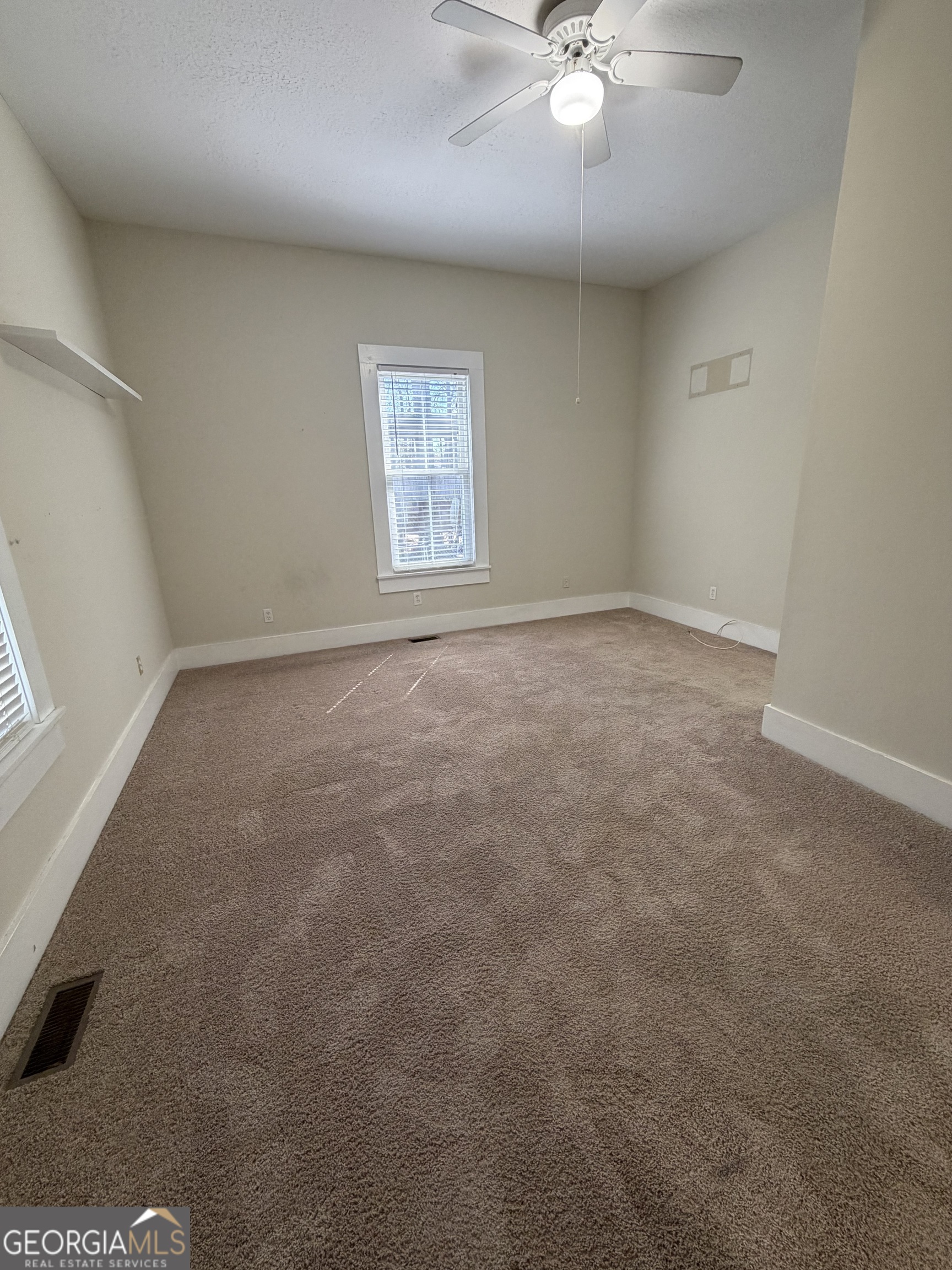 151 Tusten Street Elberton, GA 30635 - Photo 28 of 30 an empty room with a window