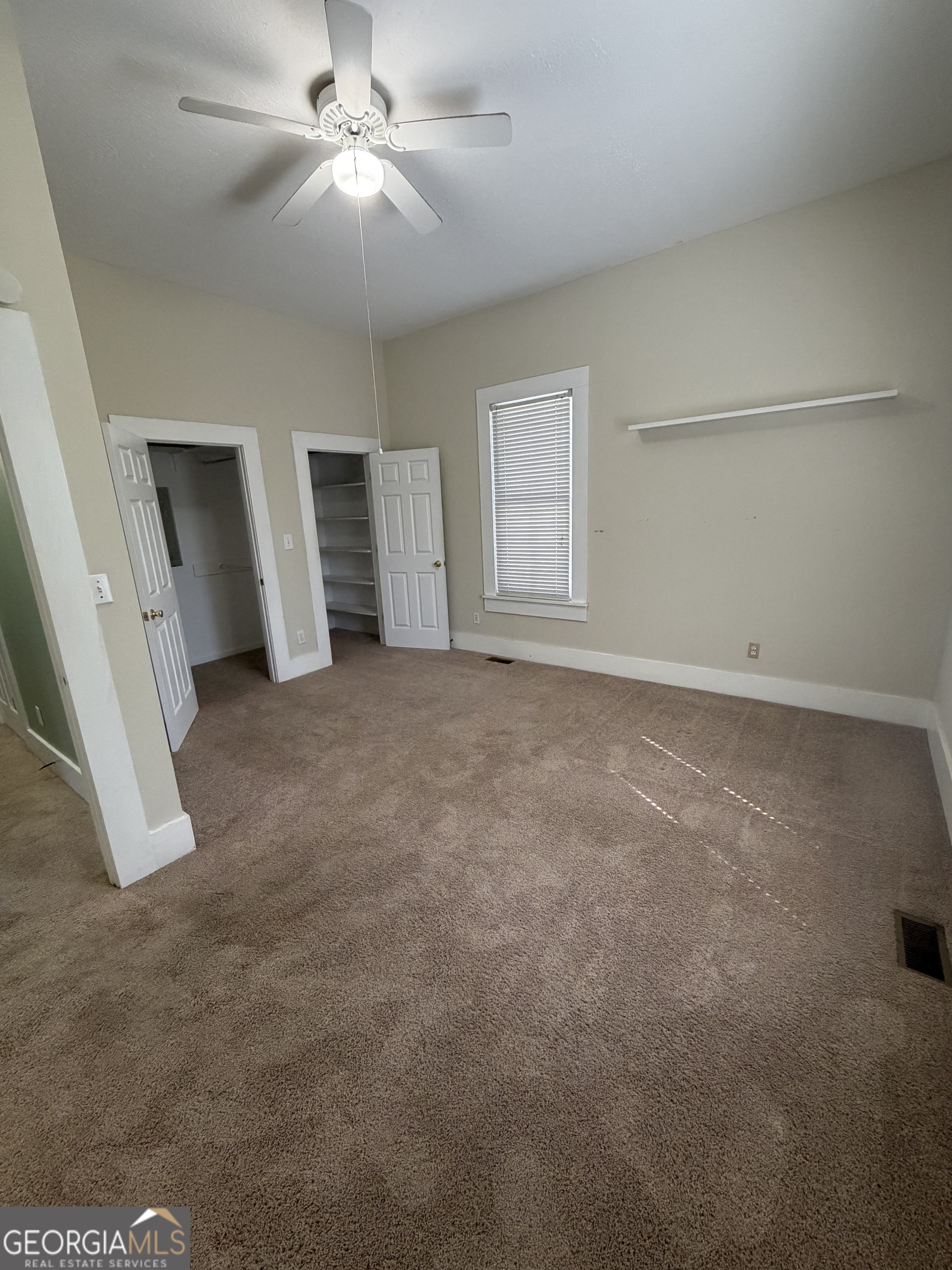 151 Tusten Street Elberton, GA 30635 - Photo 29 of 30 an empty room with closet and a ceiling fan
