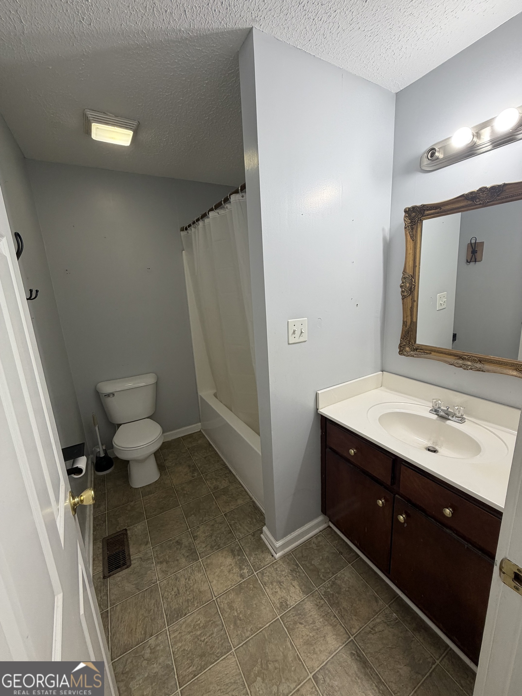 151 Tusten Street Elberton, GA 30635 - Photo 30 of 30 a bathroom with a sink vanity mirror and toilet