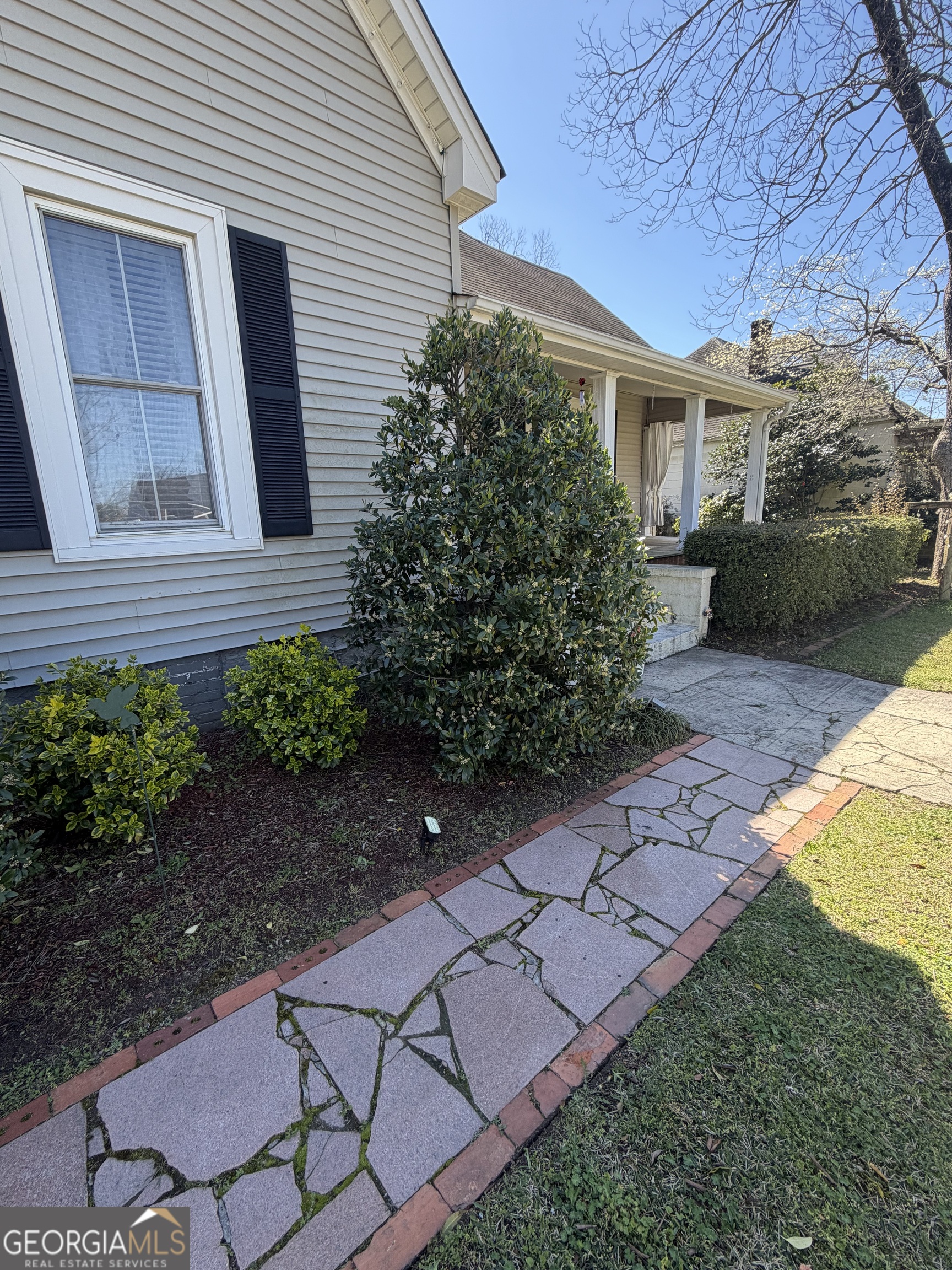 151 Tusten Street Elberton, GA 30635 - Photo 3 of 30 a view of a backyard with plants and a bench