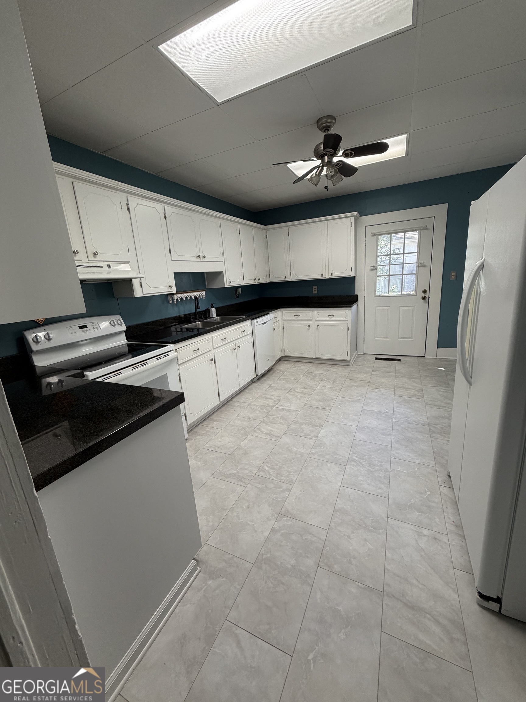 151 Tusten Street Elberton, GA 30635 - Photo 9 of 30 a kitchen with kitchen island a counter top space appliances and cabinets