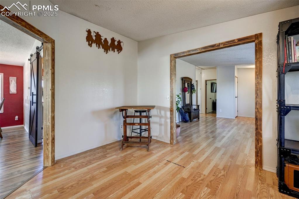 35355 Funk Road Calhan, CO 80808 - Photo 9 of 31 a view of a hallway with wooden floor and a living room