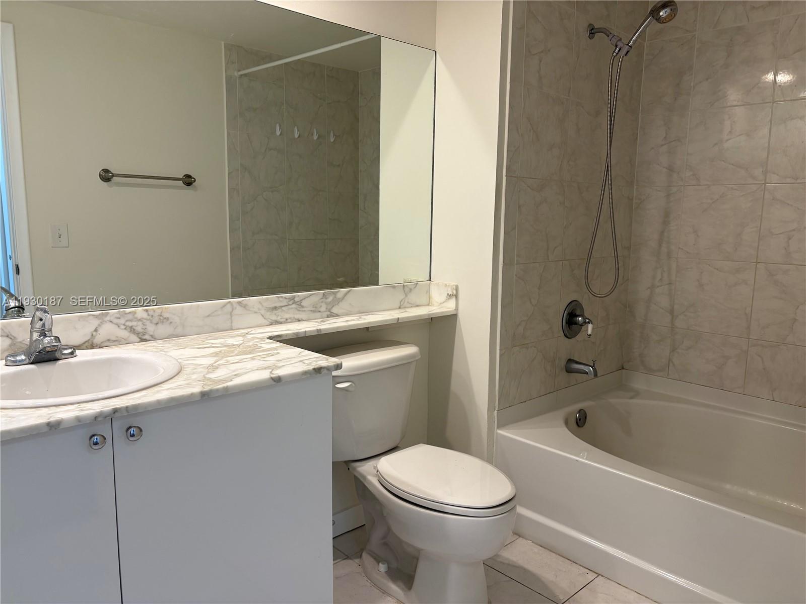 2775 Northeast 187th Street, Unit 628 Aventura, FL 33180 - Photo 9 of 19 a bathroom with a sink a toilet and shower