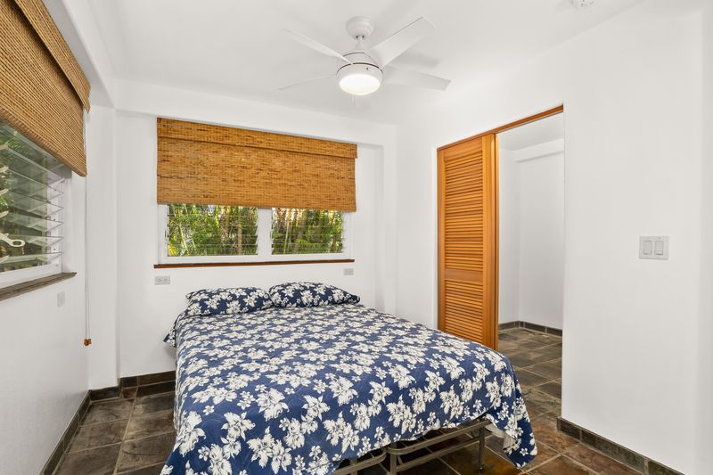 4485 Pilikoa Street Hanalei, HI 96714 - Photo 26 of 30 a bedroom with a bed and a window