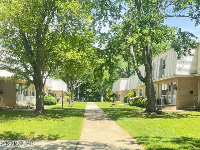 a view of a house with garden and trees