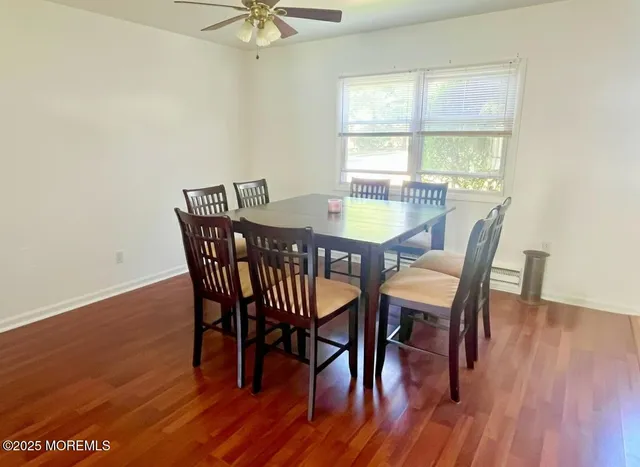 a view of a dining room with furniture window and wooden floor