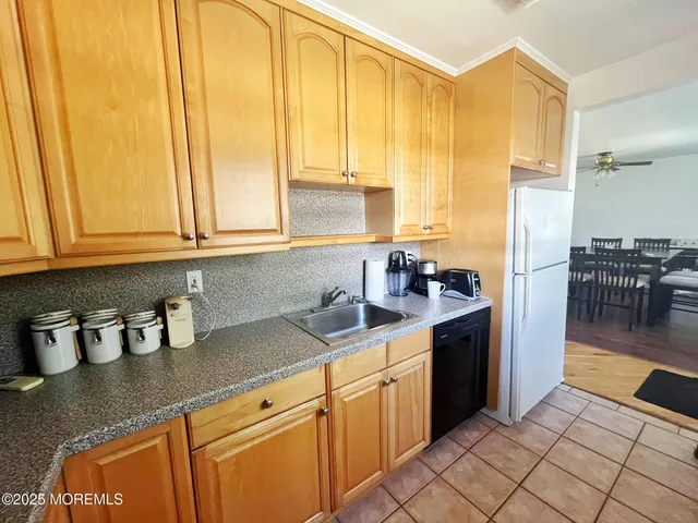 a kitchen with stainless steel appliances granite countertop a sink a stove and cabinets