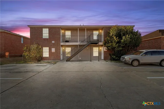 a view of a car parked in front of a building