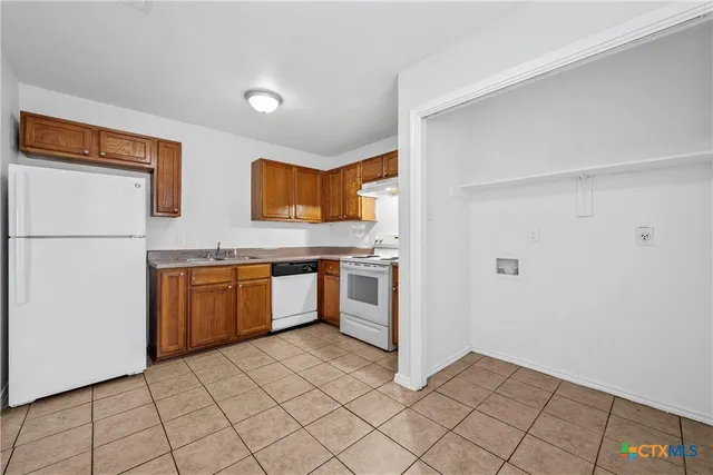 a kitchen with stainless steel appliances a refrigerator sink and cabinets