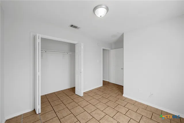 a view of an empty room and wooden floor