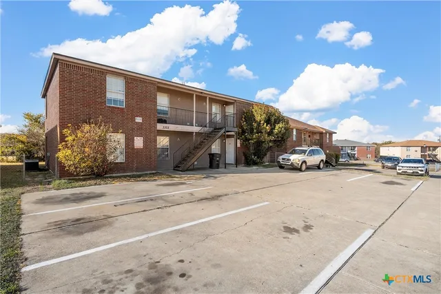 a view of a car park in front of a building