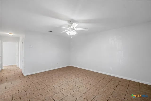 wooden floor in an empty room with a kitchen