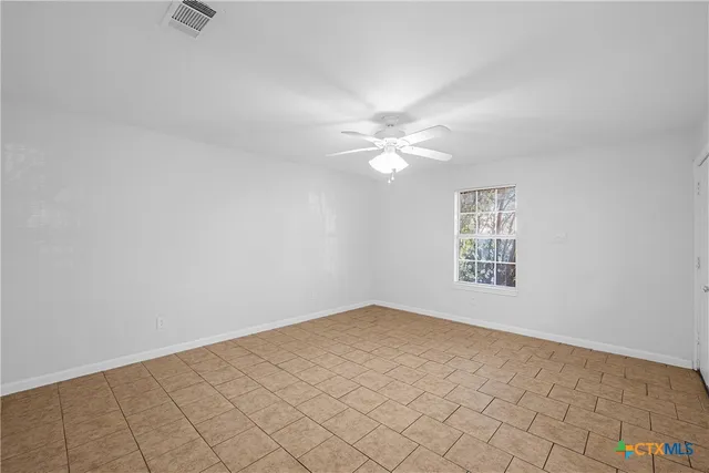a kitchen with a white stove refrigerator and cabinets