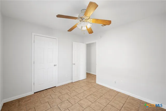 a bathroom with a granite countertop sink a toilet and a mirror