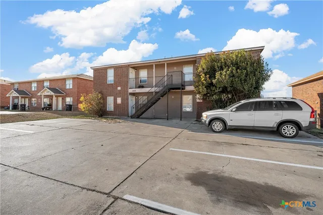 a view of a car parked in front of a house