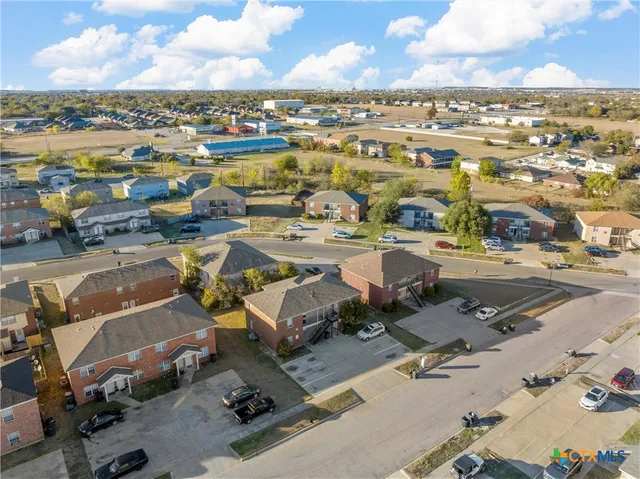an aerial view of a residential houses with city view