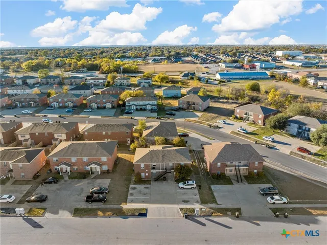 an aerial view of residential houses with outdoor space