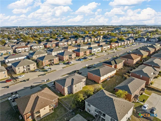 an aerial view of residential houses with outdoor space