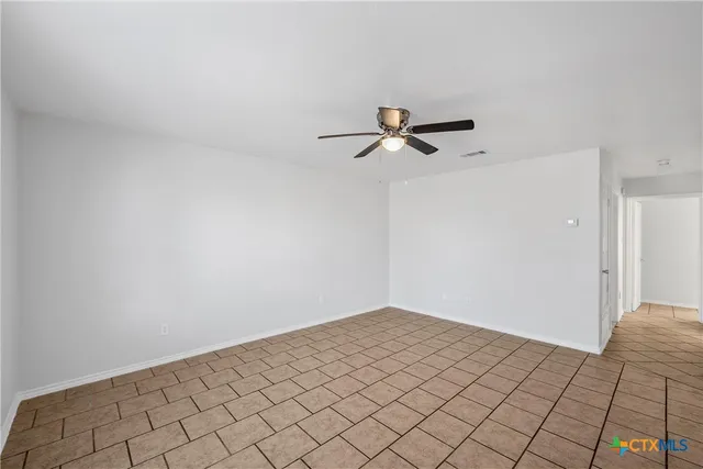 a view of a room with a white cabinet and a rug