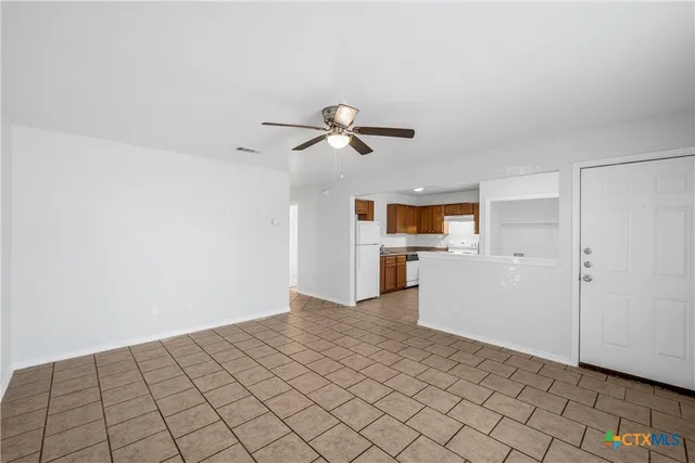 a view of a kitchen with a sink and a refrigerator