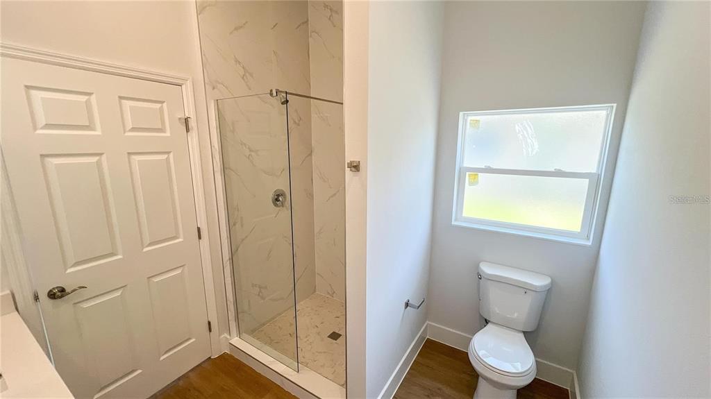 6741 Heavitree Drive Sebring, FL 33876 - Photo 13 of 29 a bathroom with a toilet and a shower