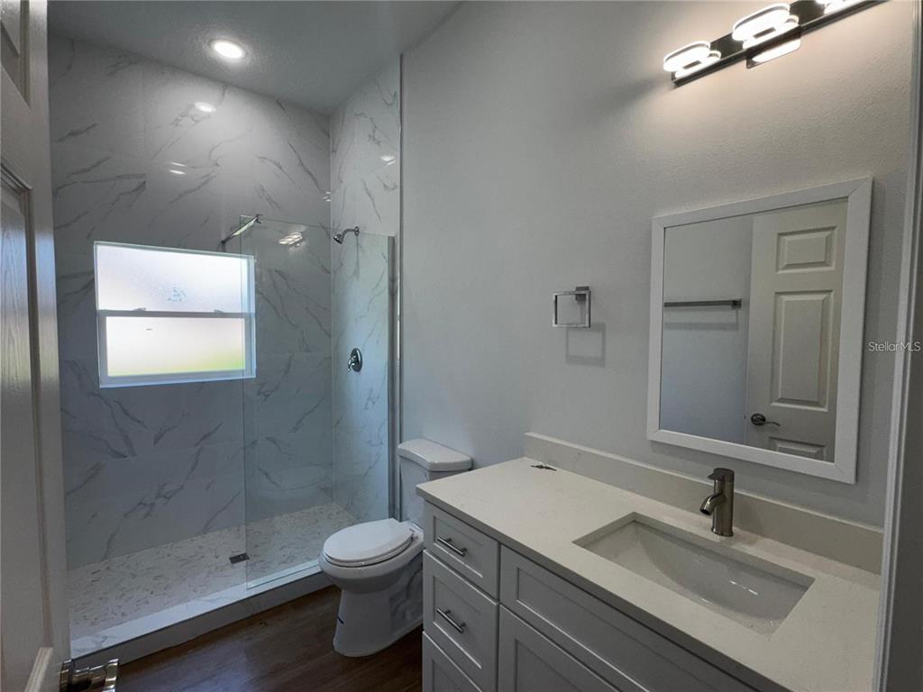 6741 Heavitree Drive Sebring, FL 33876 - Photo 19 of 29 a bathroom with a granite countertop sink a toilet and shower