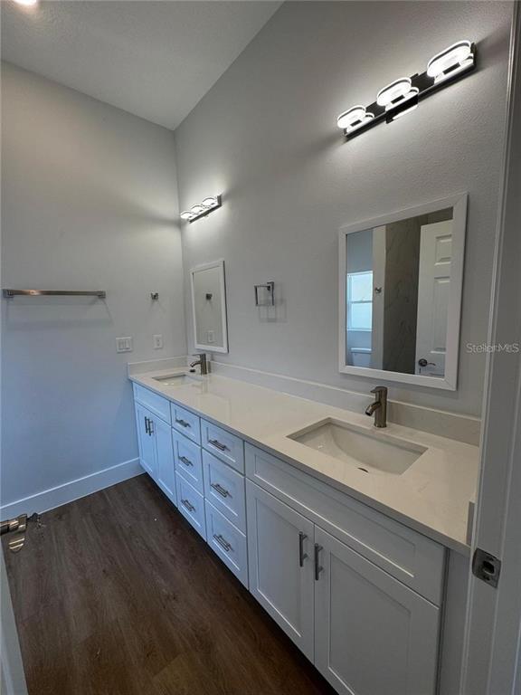 6741 Heavitree Drive Sebring, FL 33876 - Photo 22 of 29 a spacious bathroom with a double vanity sink and a mirror