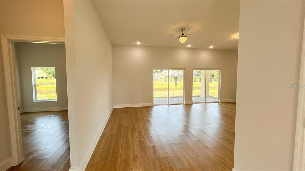 6741 Heavitree Drive Sebring, FL 33876 - Photo 7 of 29 a view of empty room with wooden floor and fan