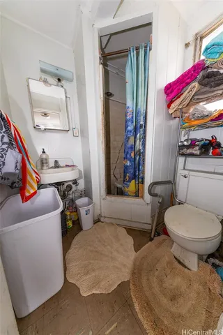 a bathroom with a toilet sink and mirror