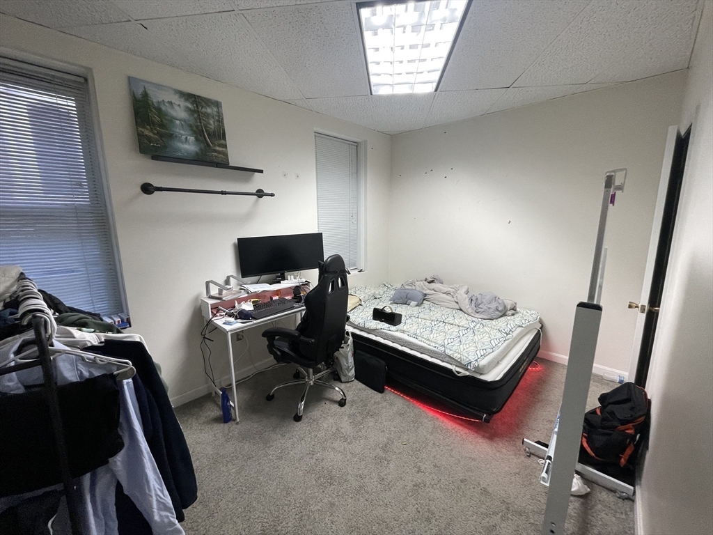 28 Kingston Street, Unit 2 Boston, MA 02110 - Photo 5 of 7 a bedroom with furniture and a window