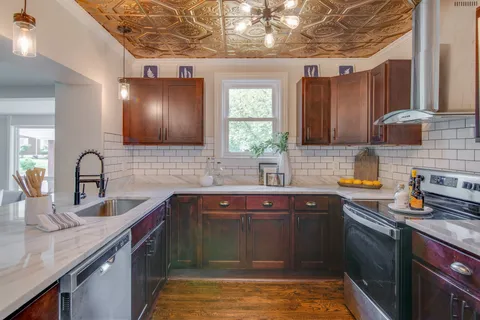 a kitchen with sink a stove and cabinets