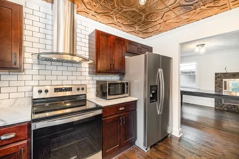 a kitchen with stainless steel appliances a refrigerator and a stove top oven