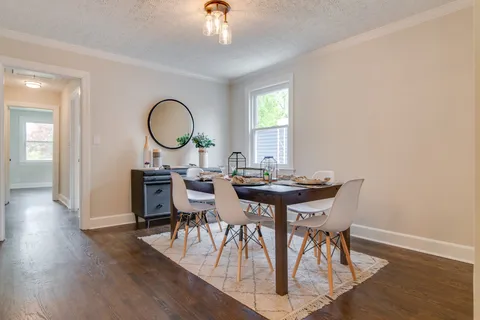 a view of a dining room with furniture and wooden floor