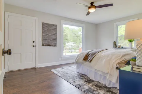 a bed sitting in a bedroom next to a window