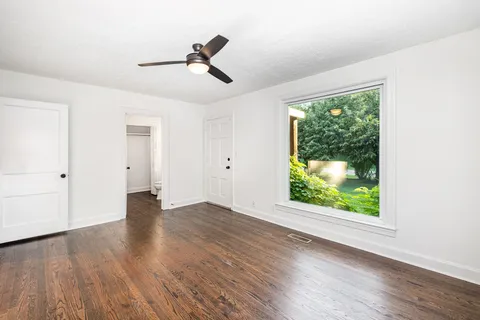wooden floor in an empty room with a window