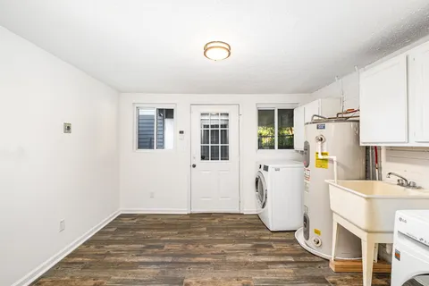 a view of empty room with wooden floor and window